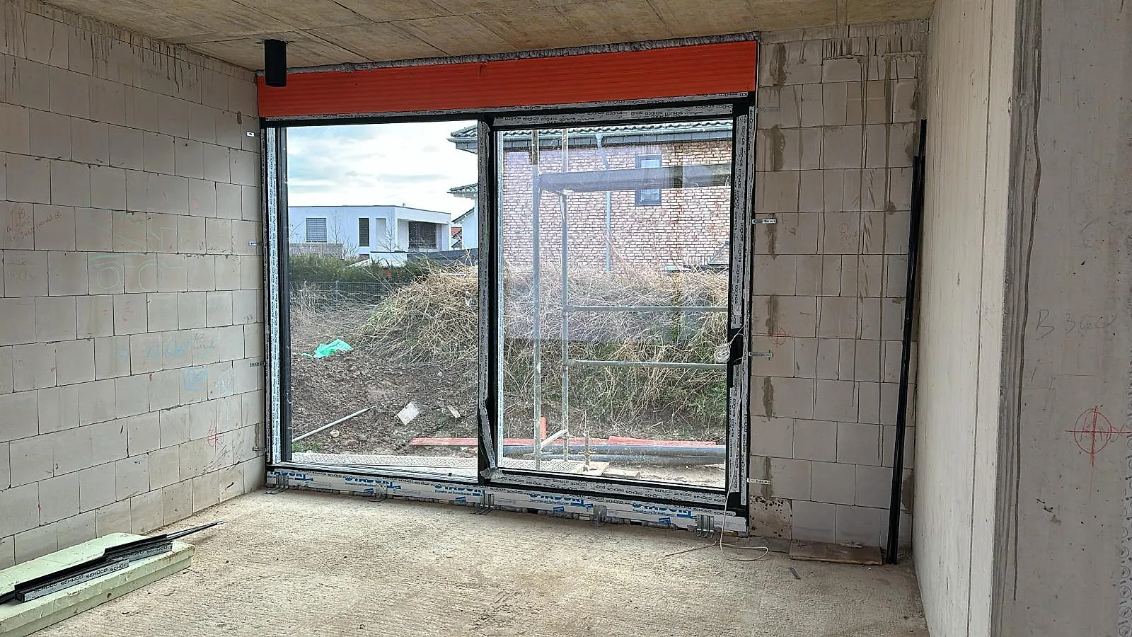 Bodentiefe Aluminiumfenster mit durchgehendem Rollladenkasten während der Montage